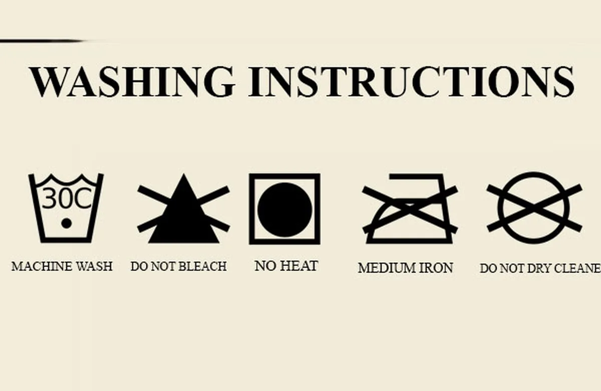 A clothing care label listing machine wash, do not bleach, and an iron setting